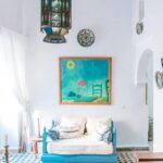 An aesthetic relaxing corner featuring a unique hanging lantern, patterned cushions, and bohemian-style tiled floors at Kuda Putih Pandawa Bali.