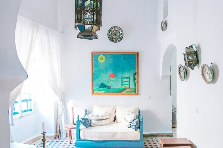 An aesthetic relaxing corner featuring a unique hanging lantern, patterned cushions, and bohemian-style tiled floors at Kuda Putih Pandawa Bali.
