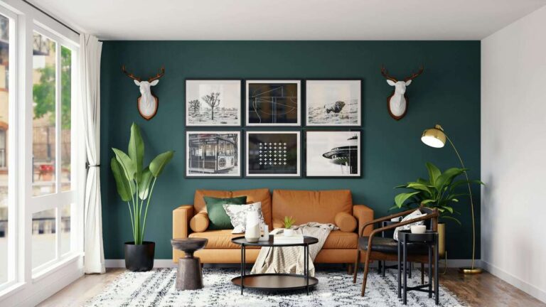A dark green living room setup featuring a warm brown leather sofa, large indoor plants, and artistic wall decor at Kuda Putih Pandawa.